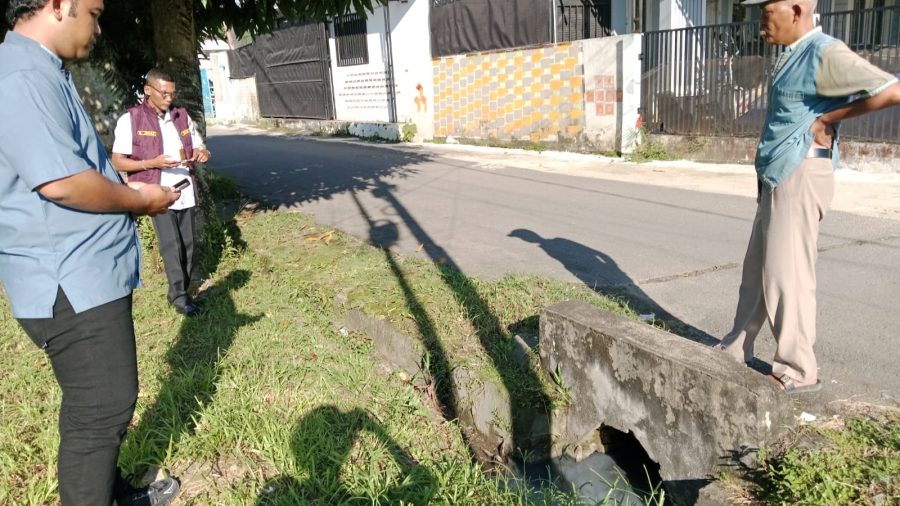 Warga meninjau limbah dan jalan rusak. FOTO: IST 