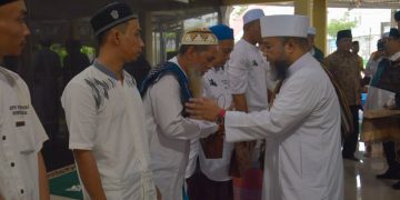 Helmi Hasan saat menyerahkan santunan kepada perwakilan warga binaan. FOTO: IST